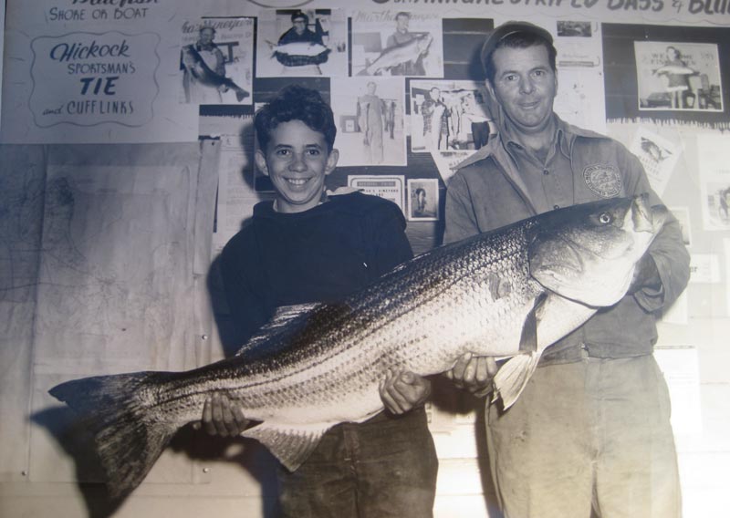 Wallace Pinkham of Vineyard Haven shows off the 1954 derby winning 55.95-pound striped bass.